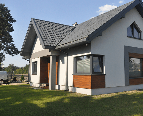 A clean, modern single storey house with green grass around it